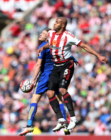 Leicester City's Jamie Vardy, left, vies for the ball with Sunderland's Younes Kaboul during the English Premier League soccer match between Sunderland and Leicester City at the Stadium of Light,  ...