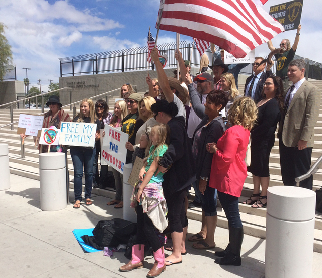 Protesters, including Assemblywoman Michele Fiore, center, pose outside of the Lloyd George Federal Building ahead of an arraignment for Ammon and Ryan Bundy, among others, in Las Vegas on Friday, ...