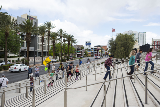 People walk towards Lloyd George Federal Building ahead of an arraignment for Ammon and Ryan Bundy, among others, in Las Vegas on Friday, April 15, 2016. (Chase Stevens/Las Vegas Review-Journal) F ...