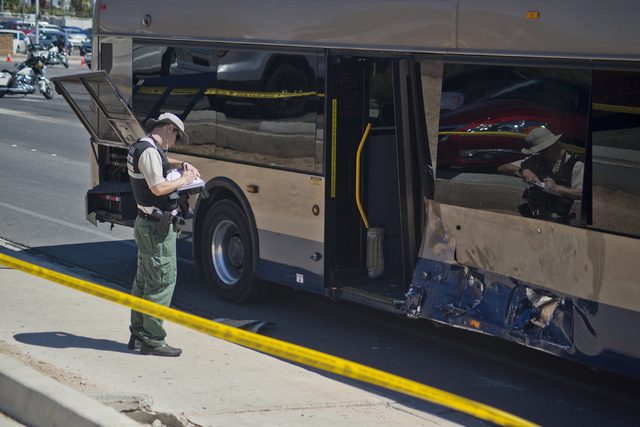 A crime scene investigator takes notes at the scene where an RTC bus and a pickup truck collided at the corner of Sahara Avenue and McLeod Drive in Las Vegas Sunday, April 17, 2016. Daniel Clark/L ...