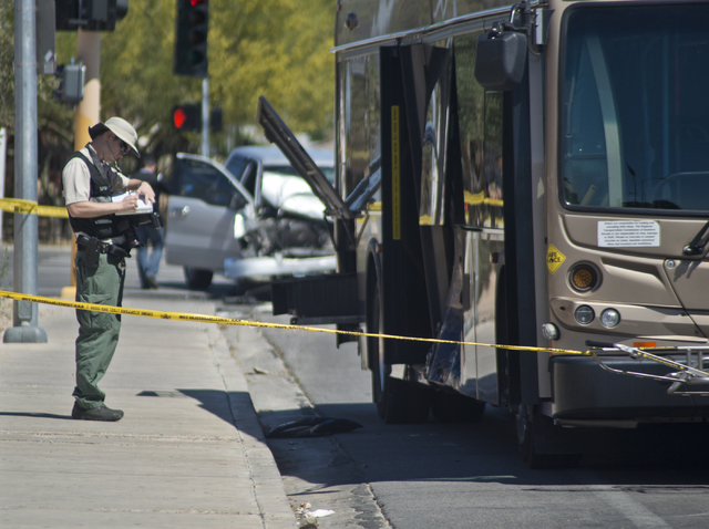 A crime scene investigator takes notes at the scene where an RTC bus and a pickup truck collided at the corner of Sahara Avenue and McLeod Drive in Las Vegas Sunday, April 17, 2016. Daniel Clark/L ...