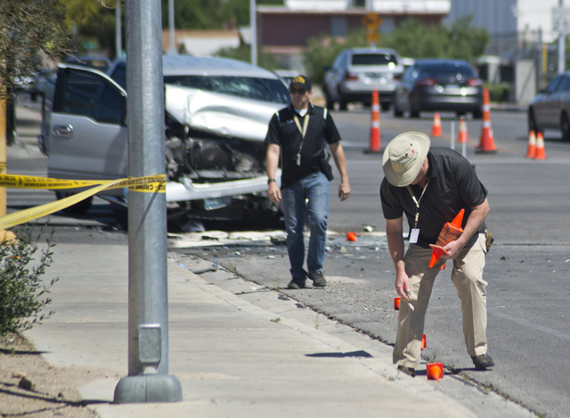 Investigators survey the the scene where an RTC bus and a pickup truck collided at the corner of Sahara Avenue and McLeod Drive in Las Vegas Sunday, April 17, 2016. Daniel Clark/Las Vegas Review-J ...
