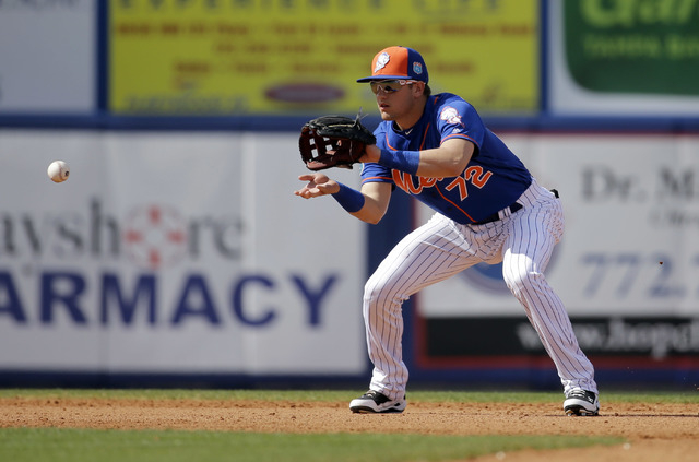 New York Mets shortstop Gavin Cecchini, now with the Las Vegas 51s, handles a grounder hit by St. Louis Cardinals' Brandon Moss during the sixth inning of an exhibition game March 10, 2016, in Por ...