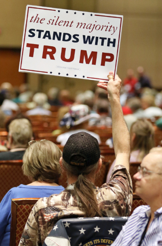 A Donald Trump supporter holds up a sign during candidate speeches at the Clark County Republican Party county convention at the Rio hotel-casino Saturday, April 9, 2016, in Las Vegas. Ronda Churc ...
