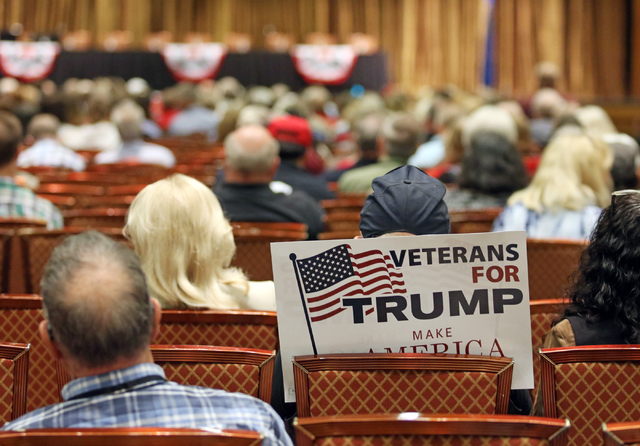 A Donald Trump supporter sits with a sign during candidate speeches at the Clark County Republican Party county convention at the Rio hotel-casino Saturday, April 9, 2016, in Las Vegas. Ronda Chur ...