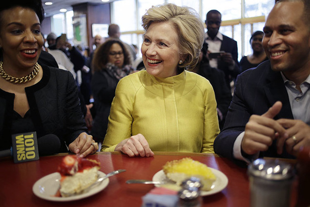 Hillary Clinton, center, talks with Rep. Hakeem Jeffries, D-N.Y., right, and Council Member Laurie Cumbo as she sits at the counter of Junior's restaurant in the Brooklyn borough of New York, Satu ...