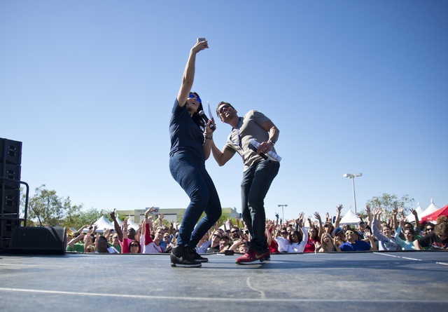 Mercedes Martinez, left, and J.C. Fernandez of KXMB-FM, Mix 94.1take a selfie with the crowd during the 26th annual Aid for AIDS of Nevada (AFAN) AIDS Walk Las Vegas at Town Square in Las Vegas on ...