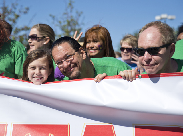 Penn Jillette, center, his daughter Moxie, left, and Teller stand at the starting line for the 26th annual Aid for AIDS of Nevada (AFAN) AIDS Walk Las Vegas at Town Square in Las Vegas on Sunday,  ...
