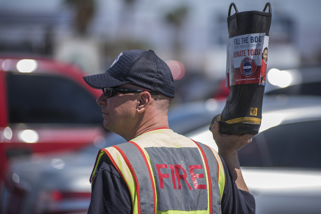 Captain John Hurley, of Firestation 44, greets motorists to collect donations for the annual "Fill the Boot" drive that benefits the Muscular Dystrophy Association (MDA) at the c ...