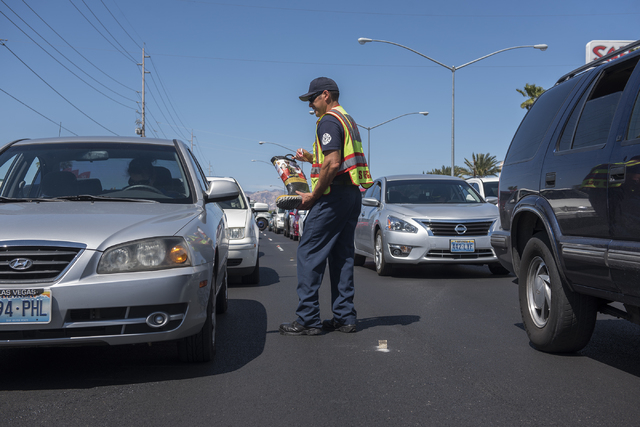 Fire Engineer Kurt Bacca, collects donations from motorists for the annual &quot;Fill the Boot&quot; drive that benefits the Muscular Dystrophy Association (MDA) at the corner or Sahara Av ...