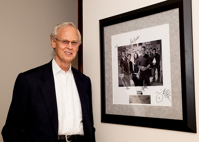 Longtime Las Vegan and attorney John Gubler shows off a signed framed autographed photograph of “Criminal Minds’”’ first season cast. (TONYA HARVEY/REAL ESTATE MILLIONS)