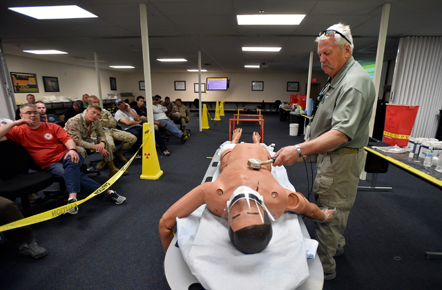Stu Estibo monitors a "victim" for radiation exposure during a decontamination exercise at the Counter-Terrorism Operations Support at the Nevada National Security Site on Wednesday, April 20, 201 ...
