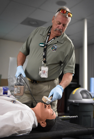 Stu Estibo monitors a "victim" for radiation exposure during a decontamination exercise at the Counter-Terrorism Operations Support at the Nevada National Security Site on Wednesday, April 20, 201 ...