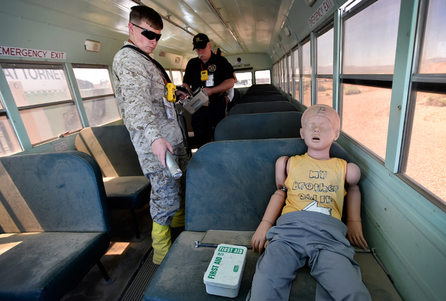 Marine Michael Seabold surveys for radioactive material near a "victim" inside a bus at the Counter-Terrorism Operations Support training facility  at the Nevada National Security Site on Wednesda ...