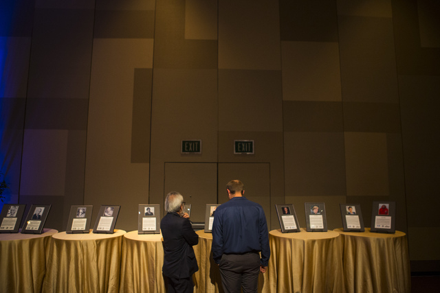 Attendees look at plaques during an event honoring 2016 DRI Nevada Medalist Dr. Mary "Missy" Cummings at the Aria hotel-casino in Las Vegas on Thursday, April 14, 2016.  (Chase Stevens/Las Vegas R ...