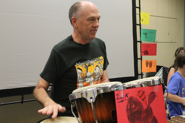 Brian Gardner plays the congas at a percussion and drum circle April 2 at the Green Valley Library. Gardner has collected drums from around the world and demonstrated how each one sounds. Michael  ...