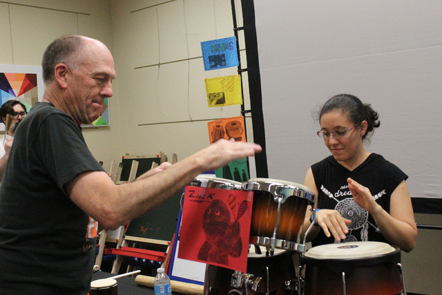 Brian Gardner shows Leidy Lester how to maintain a beat on the congas during an April 2 drum circle at the Green Valley Library, 2797 N. Green Valley Parkway. Michael Lyle/View