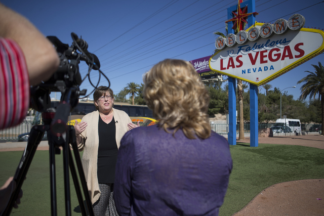 Lisa Lynn Chapman, communications coordinator for the Nevada Network Against Domestic Violence, is interviewed at the Welcome to Fabulous Las Vegas sign on S. Las Vegas Boulevard Tuesday, April 12 ...