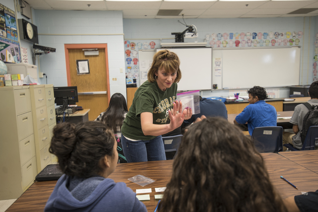 Science teacher Rebecca De Young high fives students during class at Global Community High School in Las Vegas on Wednesday, April 20, 2016. Global Community High School specializes in students tr ...