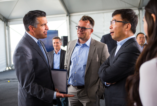 Gov. Brian Sandoval, from left, Faraday Future Vice President of Manufacturing Dag Reckhorn, and Ding Lei, Ding Lei, co-founder and global vice chairman of SEE Plan speak during the groundbreaking ...