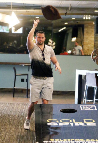 David Klics, of Warren New Jersey, plays Cornhole at Gold Spike Tuesday, March 22, 2016, in Las Vegas. Gold Spike, with new design and ownership by Downtown Project, will celebrate its third year  ...