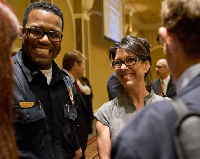 Henderson Police Sgt. Kirk Moore, left, and Henderson Code Enforcer Jeanine Abramo speak with realtors during the Greater Las Vegas Association of Realtors general membership meeting at the Orlean ...
