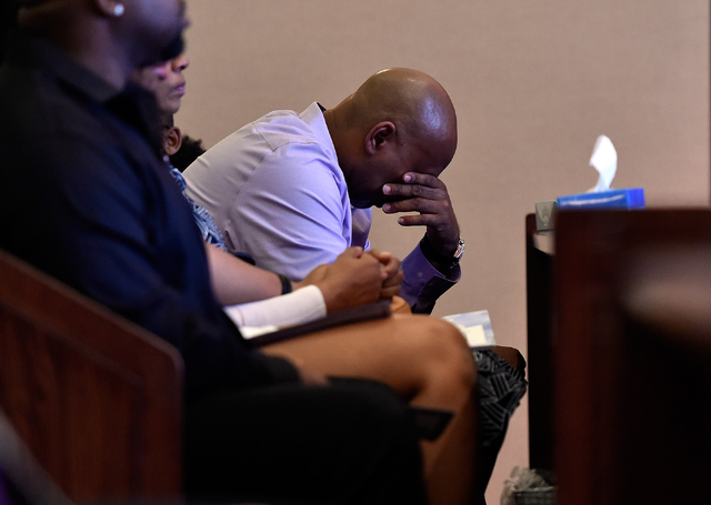 Juan Talley, the father of Felicia Hughes-Wimberly's first daughter, leans forward as he attends her funeral at Palm Mortuary on Friday, April 8, 2016. Hughes-Wimberly and her son, Branden Hughes, ...