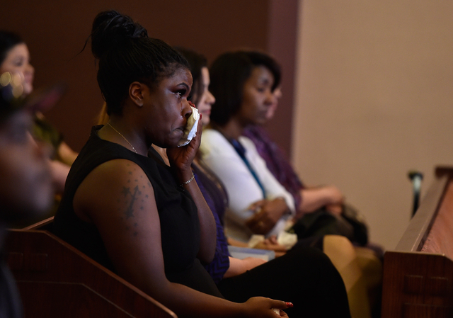 A guest wipes her tears as she attends the funeral service for Felicia Hughes-Wimberly at Palm Mortuary on Friday, April 8, 2016. Hughes-Wimberly and her son, Branden Hughes, were killed at a neig ...