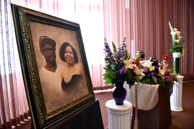 A picture of Branden Hughes and his mother Felicia Hughes-Wimberly is displayed with flowers during the funeral service for Hughes-Wimberly at Palm Mortuary on Friday, April 8, 2016. The mother an ...