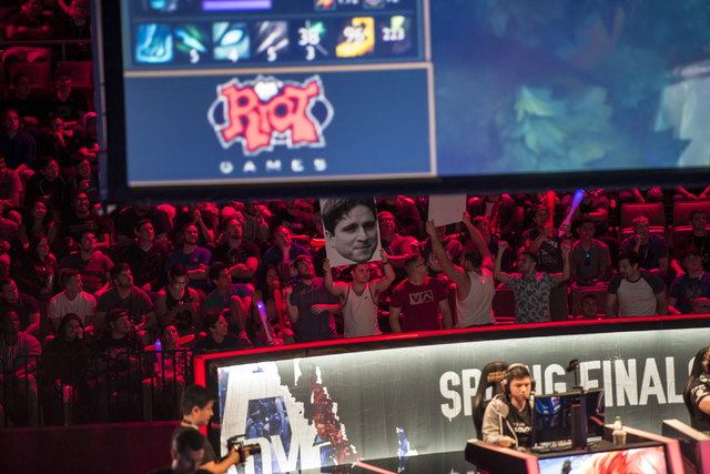 Fans hold up signs as Counter Logic Gaming battles against TSM during the North America League of Legends Championship Series Spring Final at the Mandalay Bay Event Center in Las Vegas on Sunday, ...
