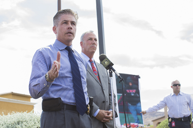 Metro homicide Lt. Dan McGrath, left, with Clark Country District Attorney Steven Wolfson, right, answers questions at the site of fatal shooting of store employee Matthew Christensen, 24, that t ...
