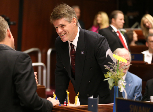 Nevada Assemblyman Chris Edwards, R-Las Vegas, talks on the Assembly floor before opening day ceremonies at the Legislative Building in Carson City, Nev., on Monday, Feb. 2, 2015. (Cathleen Alliso ...