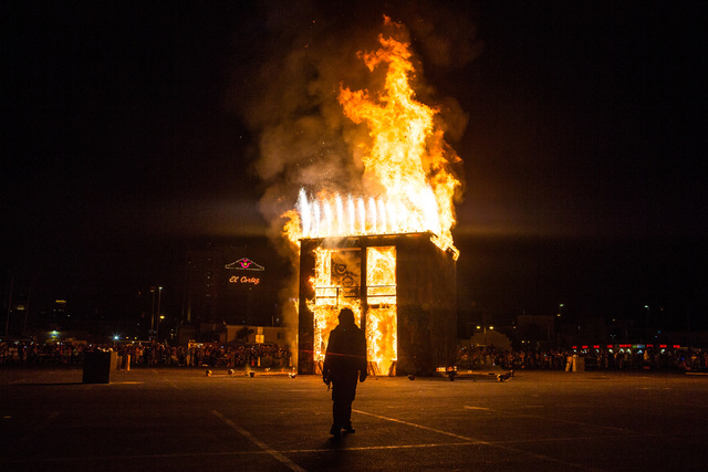 A Life Cube fire crew member is silhouetted as the fire ceremony goes on for the Life Cube in downtown Las Vegas on Saturday, April 2, 2016. (Chase Stevens/Las Vegas Review-Journal) Follow @csstev ...