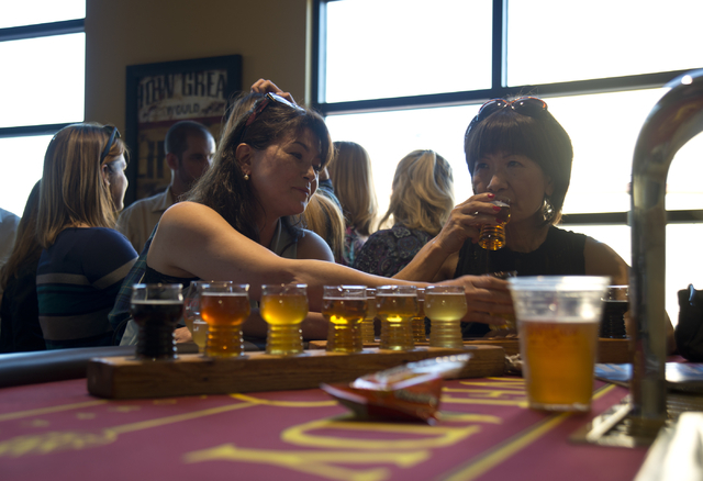 Yumi Morgan, left, and Hidemi Slyman taste a variety of beers during the grand opening of Lovelady Brewery and Taproom in downtown Henderson on Friday, April 1, 2016. (Daniel Clark/Las Vegas Revie ...