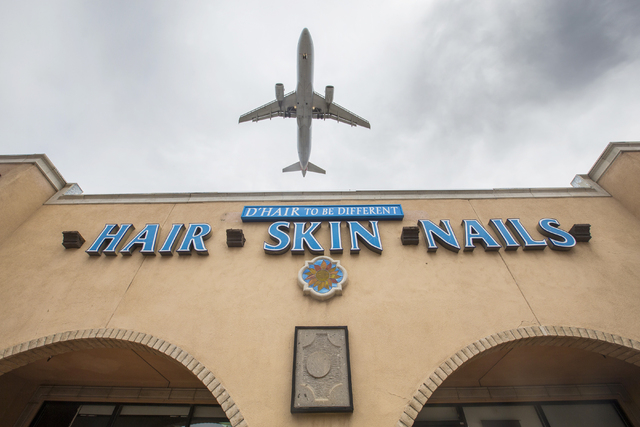 An airliner flies over D'Hair To Be Different hair salon, 6400 S. Eastern Ave., en route to McCarran International Airport, Wednesday, April 27, 2016, in Las Vegas. Benjamin Hager/Las Vegas Review ...