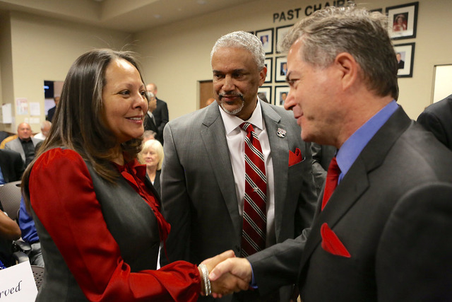 UNLV president Len Jessup, right, shakes hands with Tammy Menzies wife of new UNLV men's basketball coach Marvin Menzies, center, during a Regents meeting on Friday, April 22, 2016. (Jeff Scheid/L ...