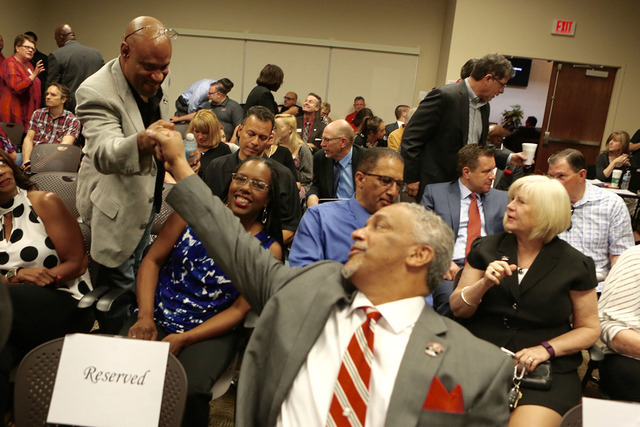 New UNLV men's basketball coach Marvin Menzies, right, fist bumps with a supporter during a Regent hearing on Friday, April 22, 2016. (Jeff Scheid/Las Vegas Review-Journal)