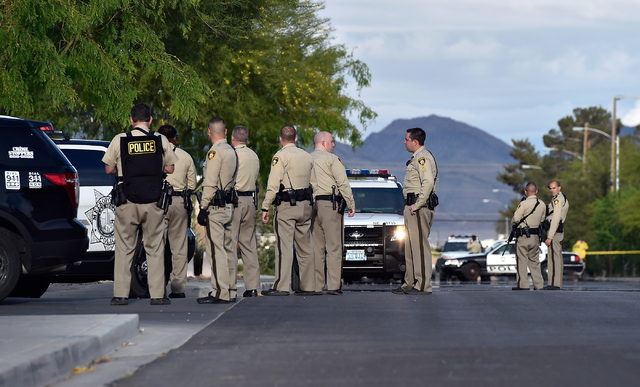 Las Vegas police stand guard outside the North East Area Command as they deal with a situation inside their station along Cecile Avenue Friday, April 8, 2016, in Las Vegas. (David Becker/Las Vega ...