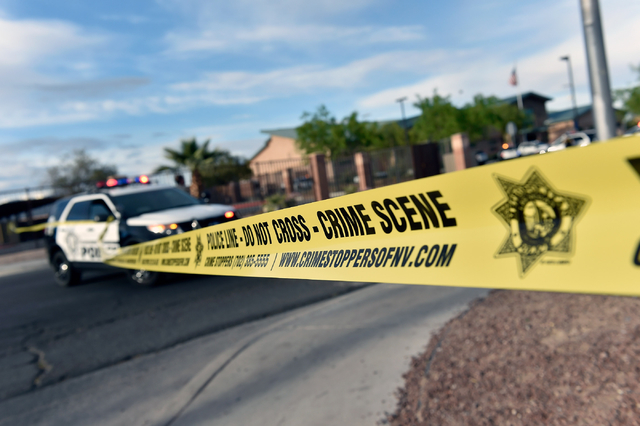 Las Vegas police stand guard outside the North East Area Command as they deal with a situation inside their station along Cecile Avenue Friday, April 8, 2016, in Las Vegas.  (David Becker/Las Vega ...