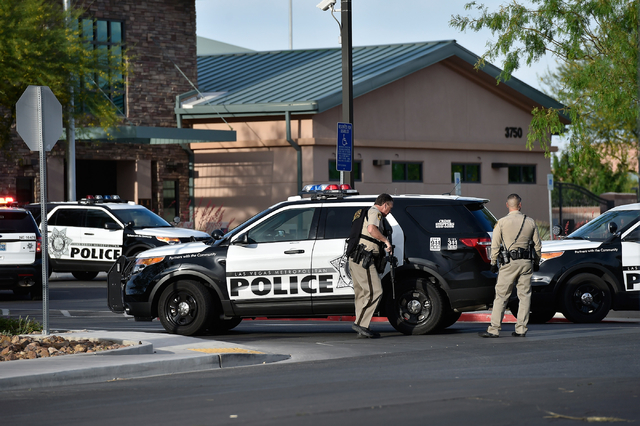 Las Vegas police stand guard outside the North East Area Command as they deal with a situation inside their station along Cecile Avenue Friday, April 8, 2016, in Las Vegas. (David Becker/Las Vega ...