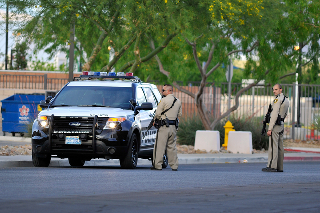 Las Vegas police stand guard outside the North East Area Command as they deal with a situation inside their station along Cecile Avenue Friday, April 8, 2016, in Las Vegas.  (David Becker/Las Vega ...