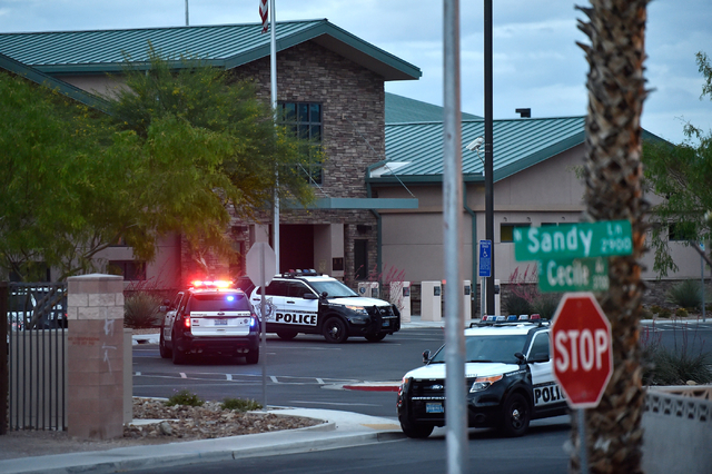 Las Vegas police stand guard outside the North East Area Command as they deal with a situation inside their station along Cecile Avenue Friday, April 8, 2016, in Las Vegas. (David Becker/Las Vega ...