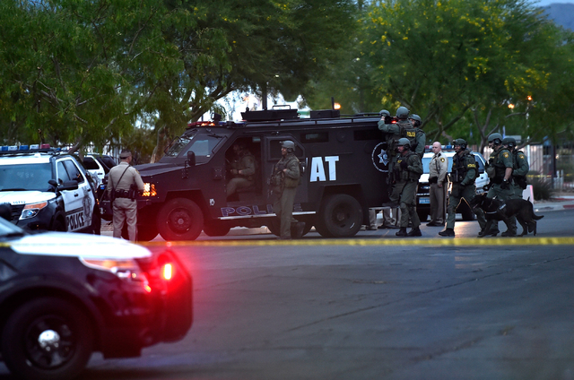The Las Vegas Metro SWAT team moves outside the North East Area Command as they deal with a situation inside their station along Cecile Avenue Friday, April 8, 2016, in Las Vegas. (David Becker/L ...