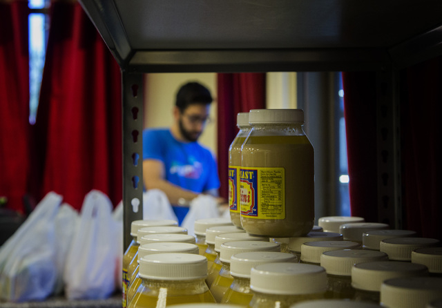 Haidar Karouni, checks out groceries while working at the his family's Afandi Restaurant, 5181 W. Charleston Blvd. on Friday, Nov. 13, 2015. Karouni is waiting for is U.S. citizenship to be approv ...
