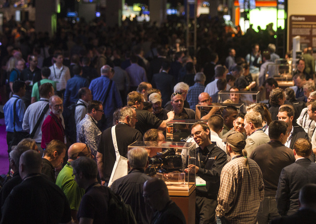 People mingle around the Blackmagic booth in the South Hall at the Las Vegas Convention Center, 3150 Paradise Road during National Association of Broadcasters Show on Monday, April 13, 2015. Aroun ...