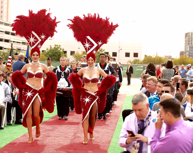 Showgirls lead dignitaries during the Project Neon groundbreaking located near The Smith Center for the Performing Arts in Las Vegas on Thursday, April 7, 2016. The $1.5 billion project will add t ...