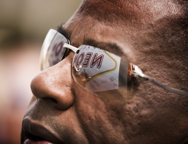 A reflection of a Project Neon sign is seen in the glasses of Clark County Commissioner Lawrence Weekly during the groundbreaking for Project Neon near The Smith Center for the Performing Arts in  ...