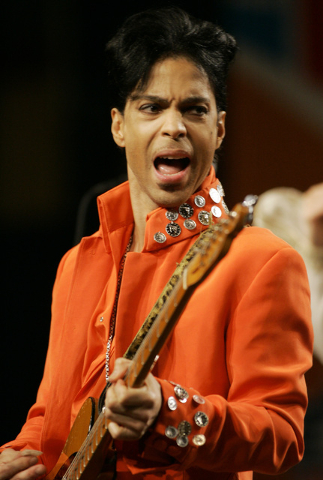 FILE - In this Feb. 1, 2007 file photo, Prince plays his guitar during a press conference at the Miami Beach Convention Center in Miami Beach, Fla. Prince's publicist has confirmed that Prince die ...