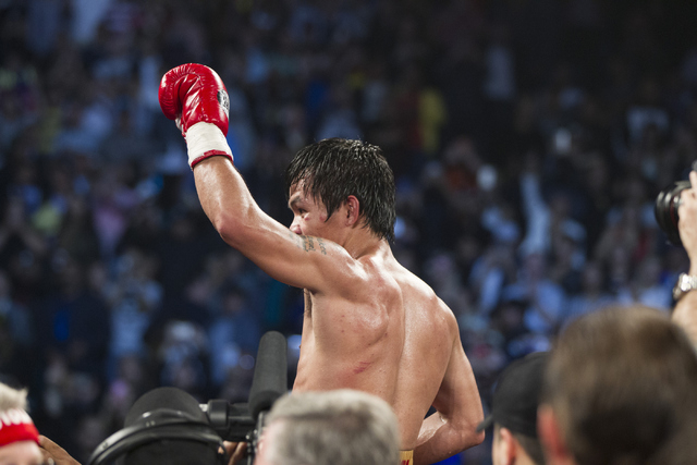 Manny Pacquiao celebrates his victory against Timothy Bradley in the WBO International welterweight championship boxing bout at the MGM Grand Garden Arena on Saturday, April 9, 2016, in Las Vegas, ...