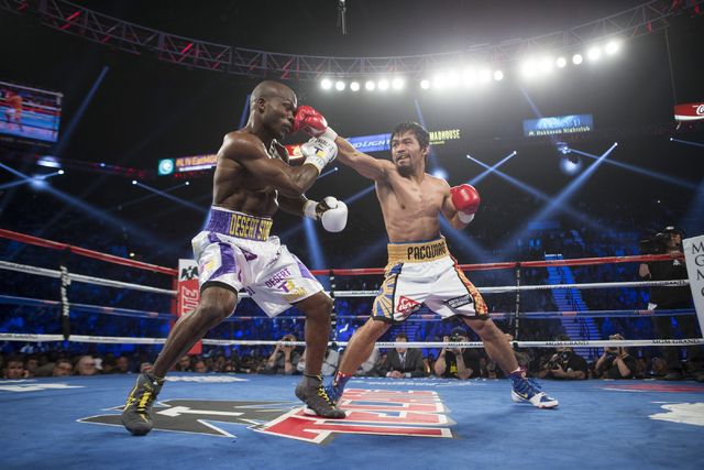 Manny Pacquiao, right, connects a right punch against Timothy Bradley in the WBO International welterweight championship boxing bout at the MGM Grand Garden ArenaSaturday, April 9, 2016, in Las Ve ...